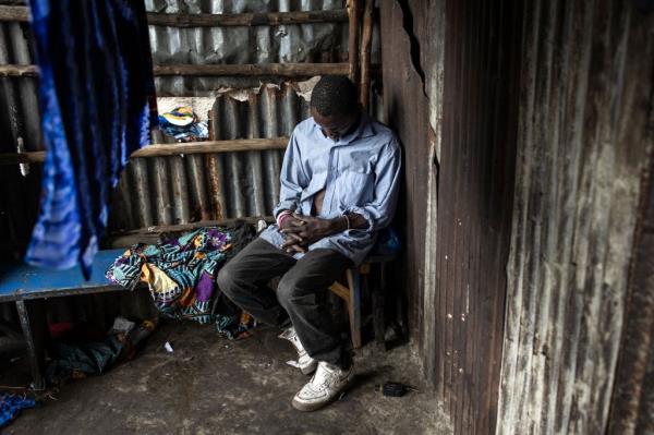 A man asleep in a drug den at the Kington landfill site in Freetown, reflecting the detrimental impact of kush among Sierra Leone youth